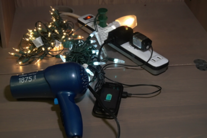 Pile of electronics: lights, hairdryer, cords
