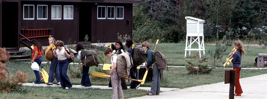 Historical photo of students with oars outside