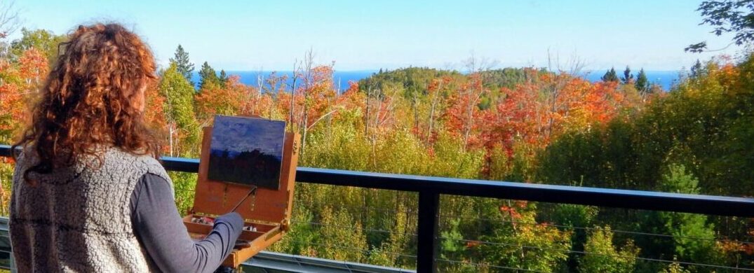 Woman Painting on Deck at Wolf Ridge in Autumn