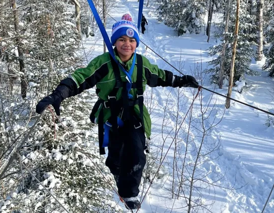 Student on ropes course in winter at Wolf Ridge