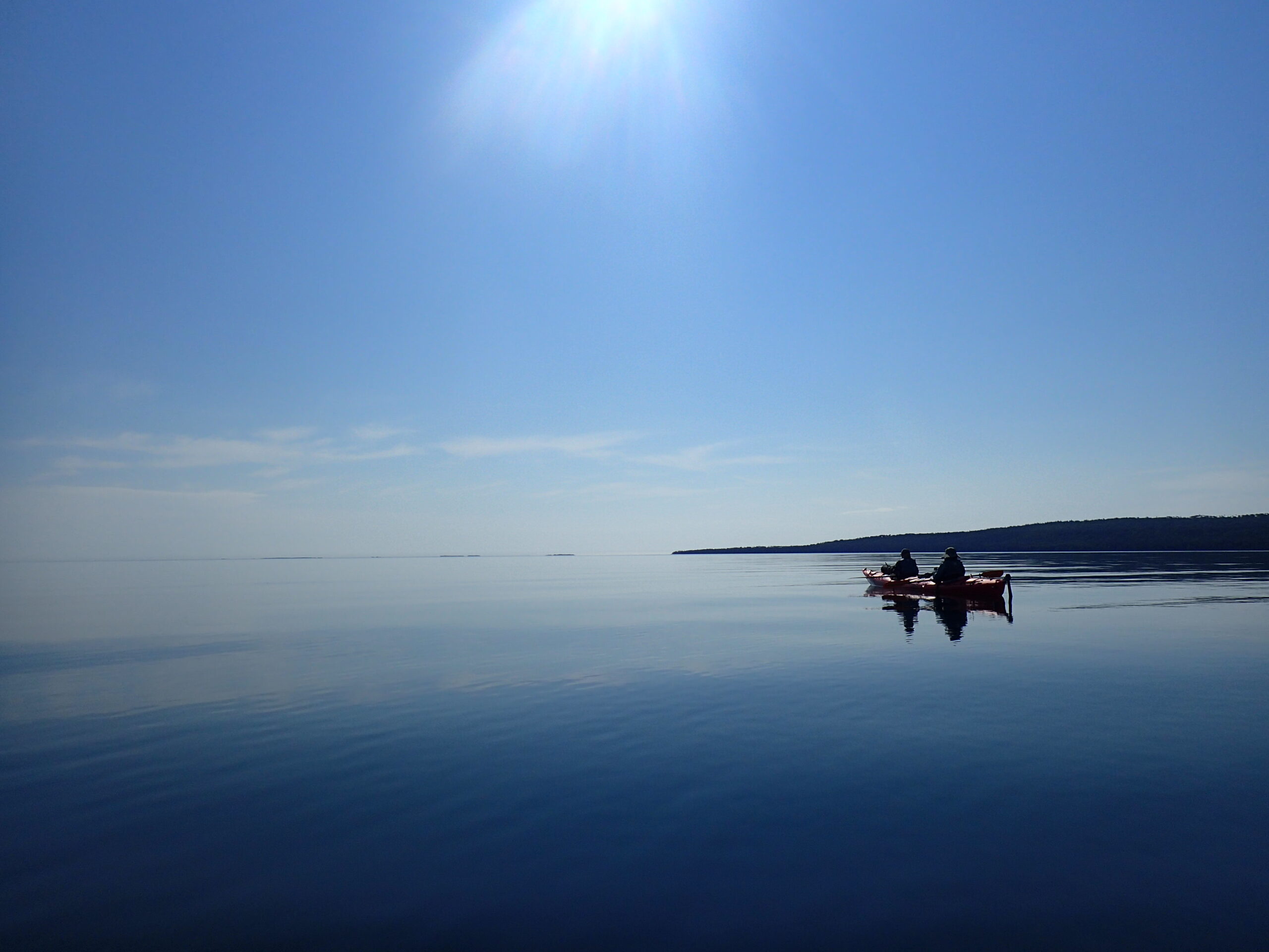 Two people in a kayak on a still body of water