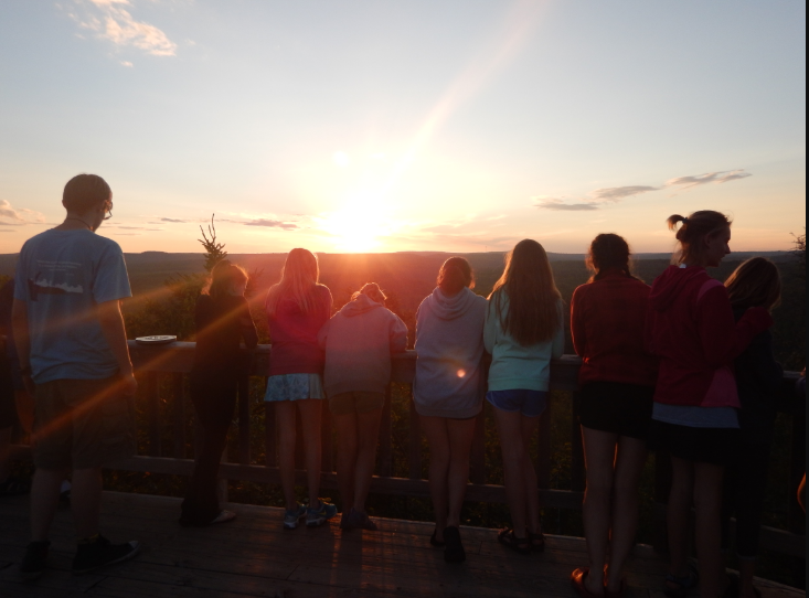This image has an empty alt attribute; its file name is students-watching-sunset-from-deck.png